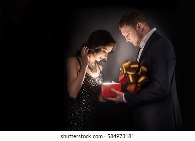 Man And Woman Opening Gift