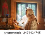 Man and  woman in an Orthodox church pray at an icon. St. Petersburg, Russia - August 2, 2020.