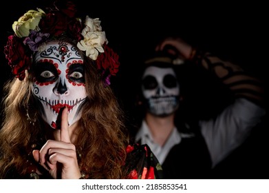 Man And Woman In Paired Halloween Costumes. Body Art Santa Muerte And Skeleton