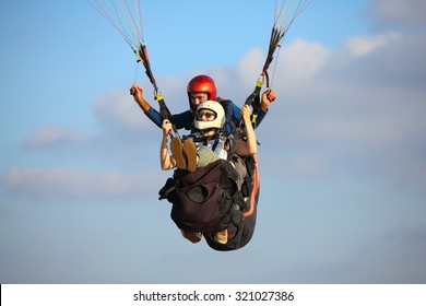 A man and woman paragliding - Shutterstock ID 321027386