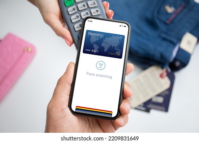 Man And Woman Payment Purchase For Phone With Face Scanning Id And Payment Purchase On Pay Pass Online Terminal  
In Store