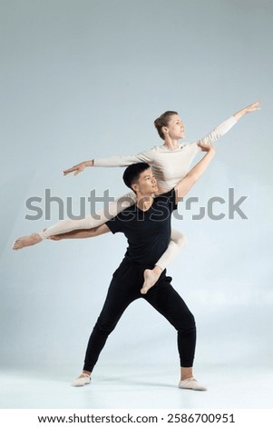 Similar – Image, Stock Photo Vertical composition. Ballerina in the studio at rehearsal. Spotlights and fog in blue tones. Sexually. No face