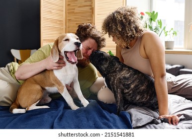 Man And Woman With Pet Dog In Bedroom