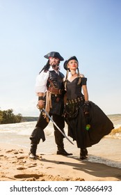 Man and woman pirates on the beach