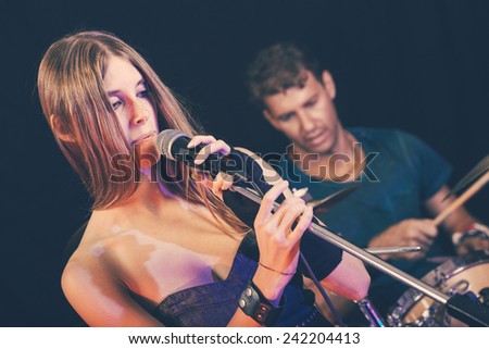 Man and Woman Playing and Singing Rock Music
