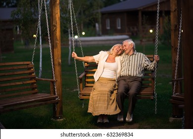 Man And Woman, Porch Swing. Senior Couple Smiling Outdoor.