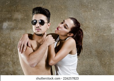 Man And Woman Posing In Studio Shot Like Young Lovers. Woman Is Rejected Or Ignored.