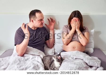 Man and woman quarrel, husband yells at pregnant wife