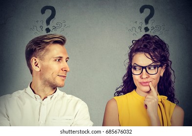 Man and woman with question mark looking at each other with interest - Shutterstock ID 685676032