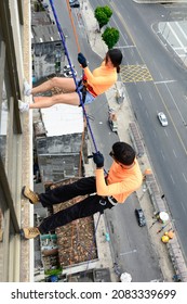 A Man And A Woman, Rappellists, Going Down The Elevator. Very Tall Monument. Salvador Bahia Brazil.