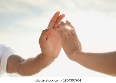 Man And Woman Reaching Hands To Each Other At Sunset, Closeup. Nature Healing Power