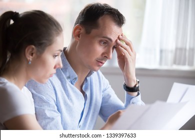 Man and woman reading contract for real estate property purchase. Employer and employee, customer and client, boss and worker, teacher and student, husband and wife studying contract. People at work