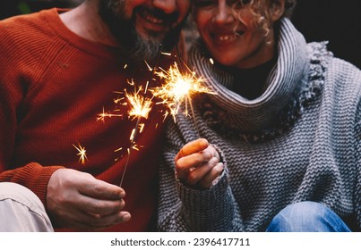 Man and woman in relationship celebrate together anniversary with sparkler lights in outdoors leisure activity. Romance and romantic people celebrating love. Concept of romanticism and love together - Shutterstock ID 2396417711