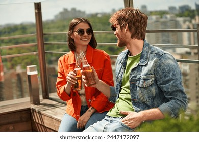 A man and a woman relax on a bench, savoring beers as they share a tranquil moment together in a peaceful setting - Powered by Shutterstock