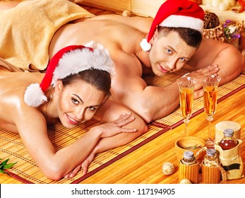 Man and woman relaxing in Christmas spa.