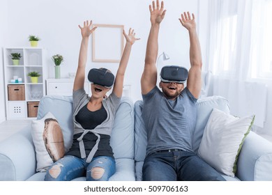 Man And Woman Relaxing At Home Having Fun With 3D Roller Coaster