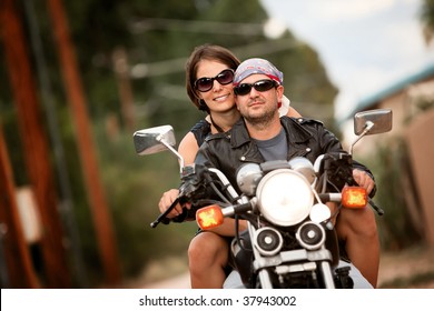 Man And Woman Riding On Vintage Motorcycle