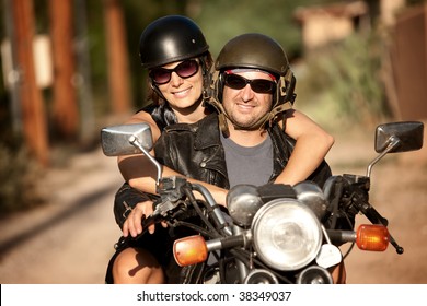 Man And Woman Riding On Vintage Motorcycle