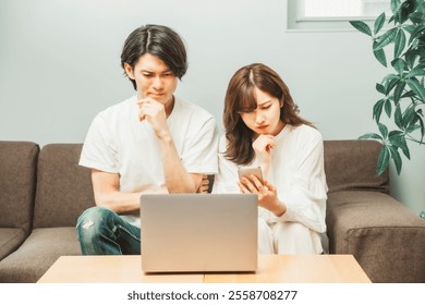 Man and woman in a room (laptop, troubled)