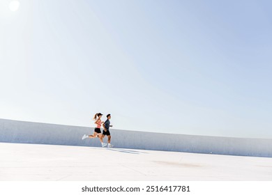 A man and woman run side by side under a clear sky on a bright, minimalist outdoor path.

 - Powered by Shutterstock