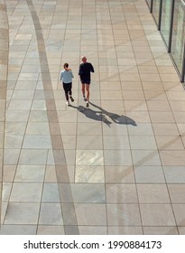 A Man And A Woman Running In Berlin. A Couple Working Out Together Outdoors. 
View From Above. 