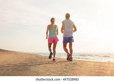 Man And Woman Running On The Beach