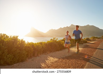 Man and woman running together on an empty road - Powered by Shutterstock