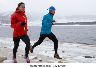 Man And Woman Running In Winter