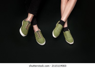 Man And Woman In Sage Color Stylish Sneakers Isolated In Black Background