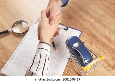 man and woman shake hands at the desktop. concept car sale - Shutterstock ID 2081848417