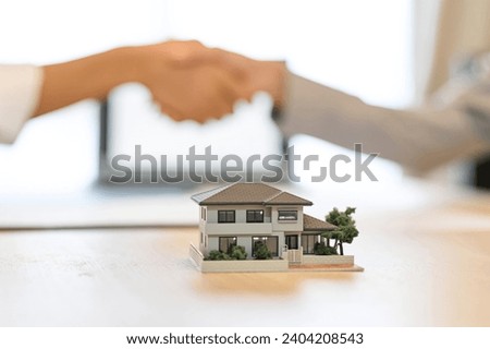 A man and a woman shaking hands during a real estate contract