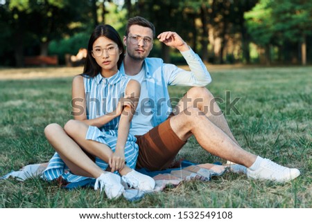 man and woman sit on grass joy relationship freedom