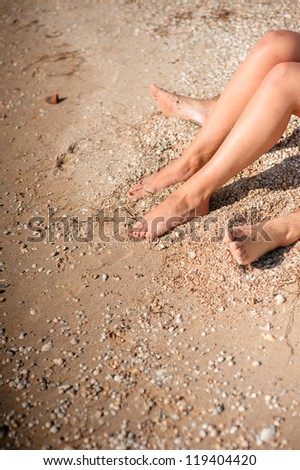 man and woman sitting on the beach