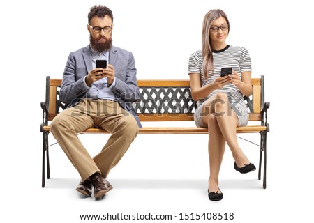 Man and woman sitting on a bench and typiing on mobile phones isolated on white background