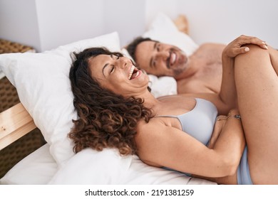 Man And Woman Smiling Confident Lying On Bed At Bedroom