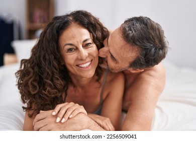 Man and woman smiling confident lying on bed kissing at bedroom - Powered by Shutterstock