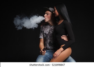 a man and woman smoking electronic cigarette
