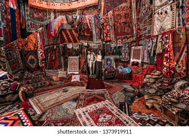 Man and woman in the store. Couple in love in Turkey. Man and woman in the Eastern country. Gift shop. A couple in love travels. Persian shop. Tourists in store. Oriental carpet. Istanbul. Cappadocia