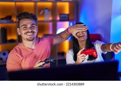 Man And Woman Streamers Playing Video Game Using Computer And Joystick Cheating At Gaming Room