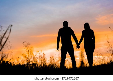 man and woman at sunset - Shutterstock ID 1719471667