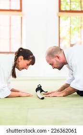 Man And Woman Take A Bow To Greet At Aikido Martial Arts School 