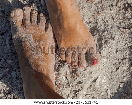 man and woman together human foot on sand in silver beach in porquerolles island france, panorama landscape