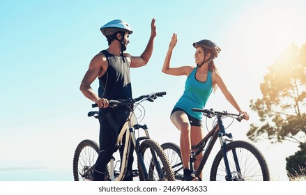 Man, woman or together on bicycle with high five in countryside for exercise, celebrate for workout goal. Team, people or bike with hands for training success on mountain, healthy motivation in sport