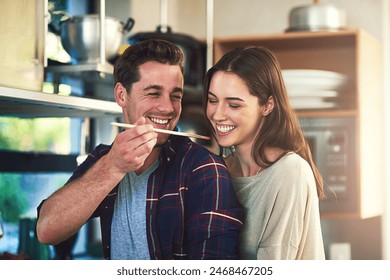 Man, woman and together with spoon for taste test in kitchen, cooking with check on soup for approval. Couple, happiness or nutrition in home for wellness, healthy food for natural vitamins in winter - Powered by Shutterstock