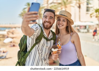 Man and woman tourist couple make selfie by smartphone eating ice cream at seaside - Powered by Shutterstock