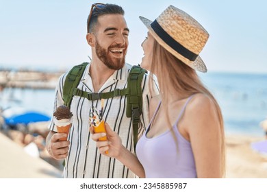 Man and woman tourist couple smiling confident eating ice cream at seaside - Powered by Shutterstock