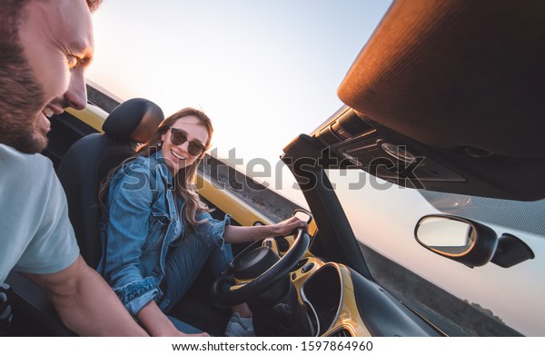 The man and woman\
traveling by car together