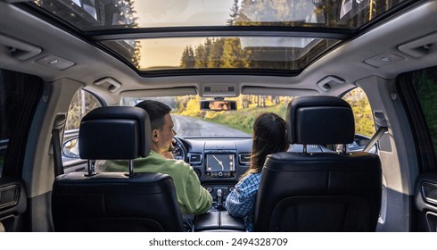 Man and woman traveling in car, sitting in car driving to travel destination. - Powered by Shutterstock