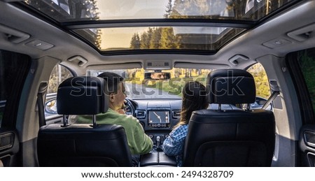 Similar – Image, Stock Photo woman driving in a car  through mountains closeup, blurred with focus on the mountain. Road trip and adventure.