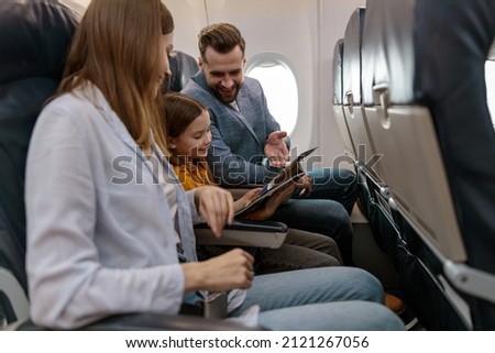 Man and woman traveling with daughter on airplane